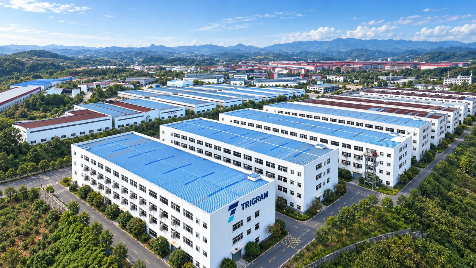 TRIGRAM brand concept showing an industrial campus with blue roofs and TRIGRAM signage
